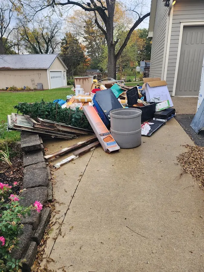 Dumpster being loaded with debris for 12 Yard Dumpster Rental in Lindale